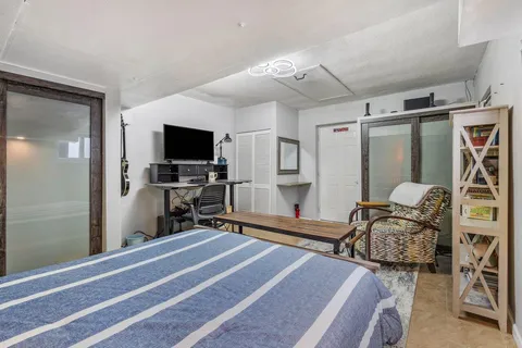 a bedroom with furniture and a flat screen tv