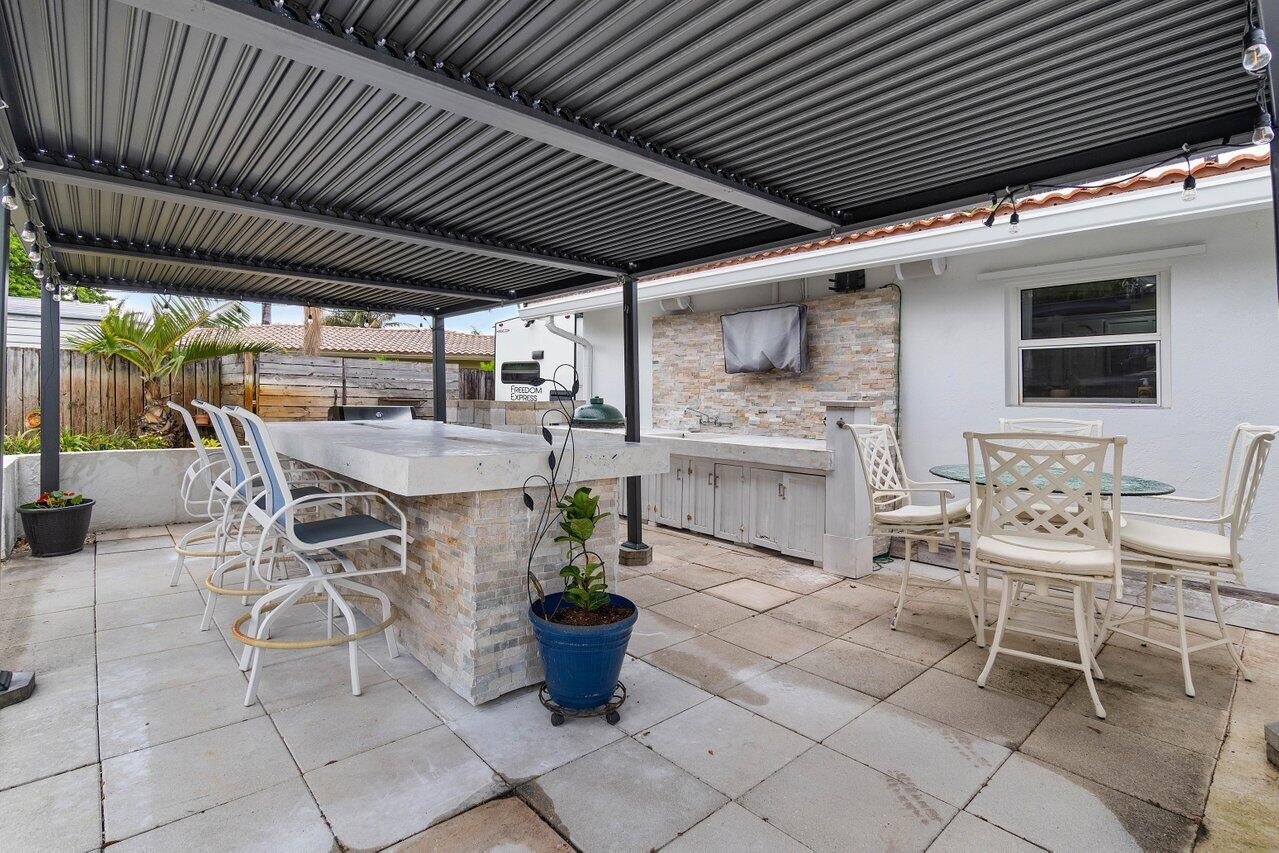5131 Northeast 27th Terrace Lighthouse Point, FL 33064 - Photo 24 of 39 a dining room with furniture and a table
