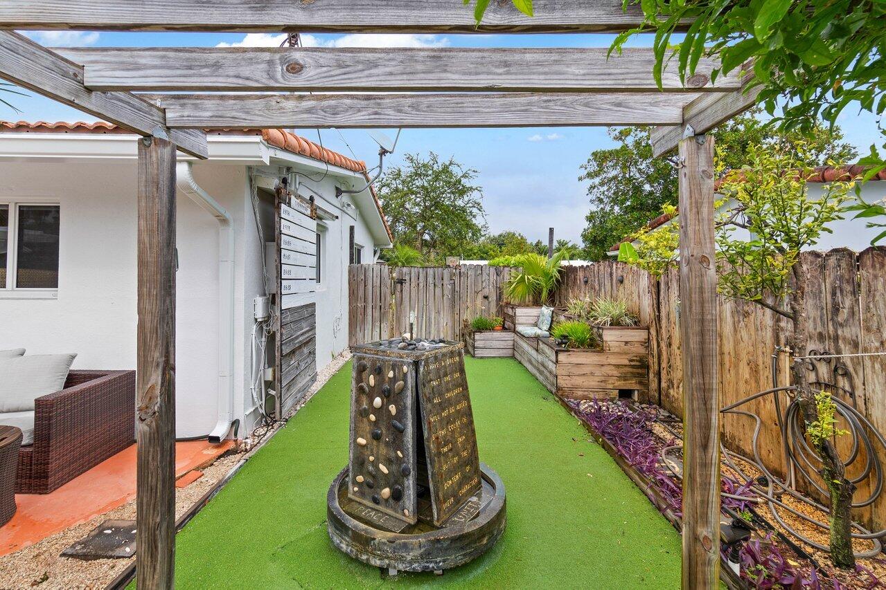 5131 Northeast 27th Terrace Lighthouse Point, FL 33064 - Photo 32 of 39 a view of a porch with furniture and a yard