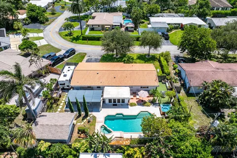 an aerial view of house with yard and swimming pool