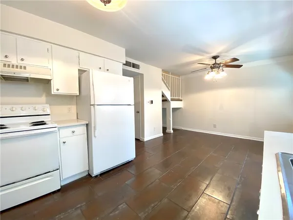 a white refrigerator freezer sitting inside of a kitchen