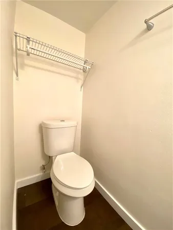a white toilet sitting next to a shower