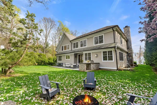 a front view of a house with a yard table and chairs