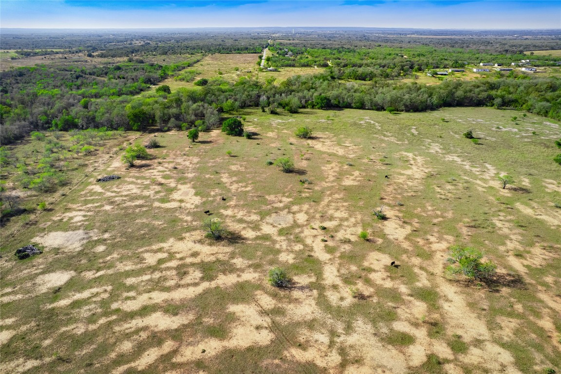 0 Bugtussle Lane Luling, TX 78648 - Photo 3 of 16 a view of a big yard with lots of green space and mountain view in back