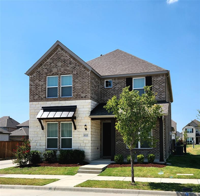 8715 Royal Star Road Rowlett, TX 75089 - Photo 2 of 39 Two-story exterior with brick and stone finishes, featuring a prominent gable roofline and a dark asphalt shingle roof