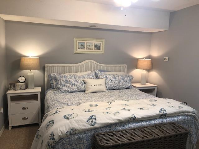 63 Sandy Lane, Unit 102 Santa Rosa Beach, FL 32459 - Photo 15 of 26 a bedroom with a bed and a night stand