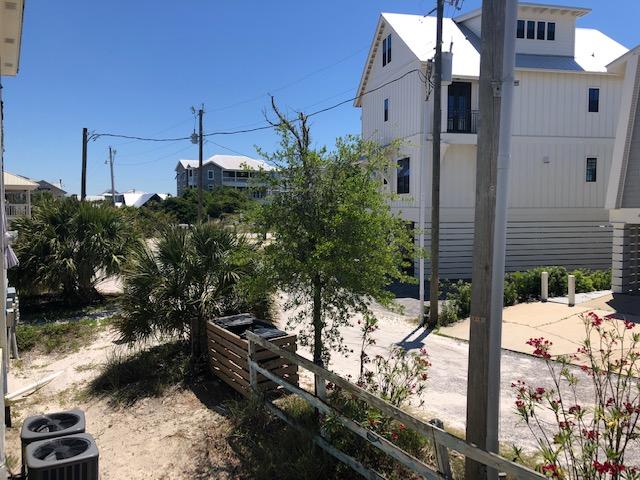 63 Sandy Lane, Unit 102 Santa Rosa Beach, FL 32459 - Photo 25 of 26 a backyard of a house with a tree