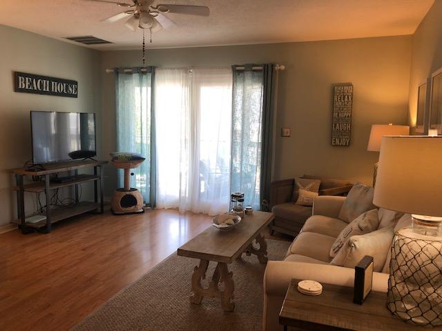 63 Sandy Lane, Unit 102 Santa Rosa Beach, FL 32459 - Photo 8 of 26 a living room with furniture and a flat screen tv