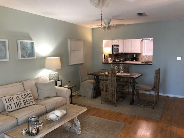 63 Sandy Lane, Unit 102 Santa Rosa Beach, FL 32459 - Photo 10 of 26 a living room with furniture a flat screen tv and kitchen view