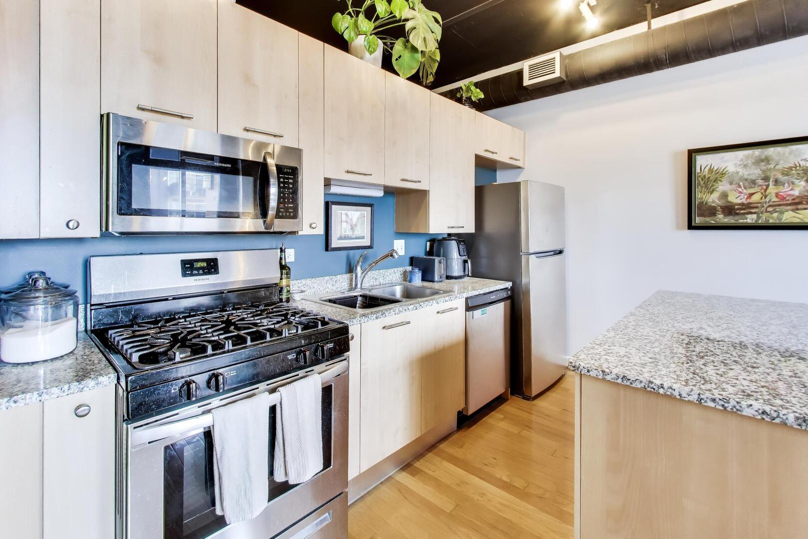 111 South Morgan Street, Unit 703 Chicago, IL 60607 - Photo 14 of 26 a kitchen with stainless steel appliances granite countertop a stove and a sink