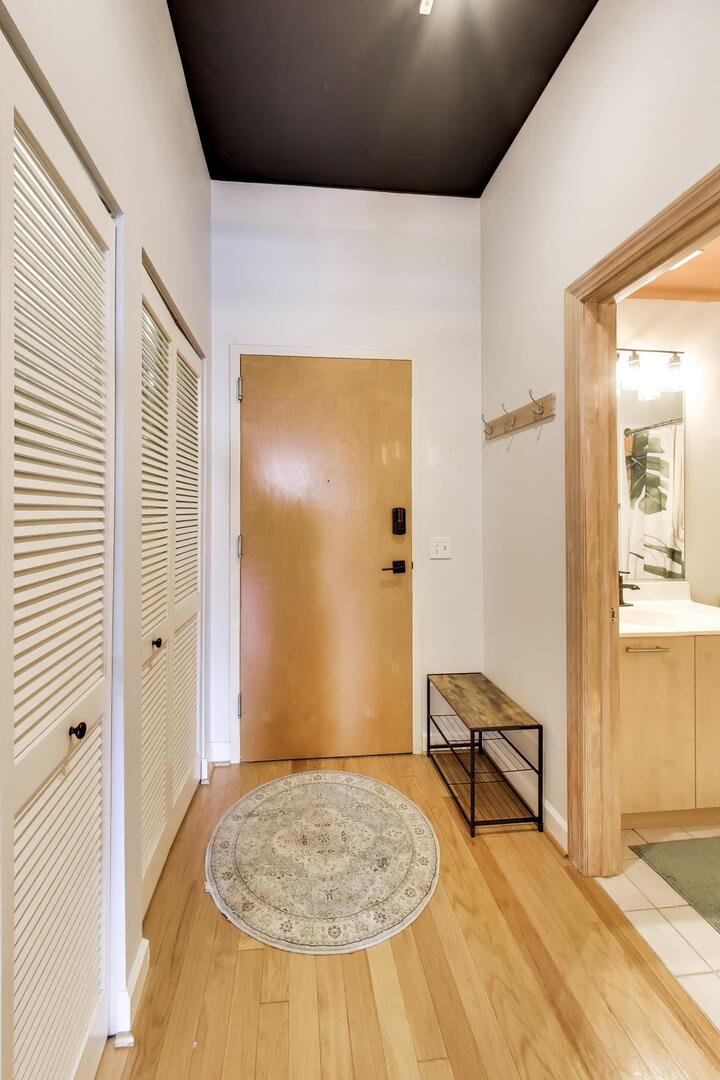 111 South Morgan Street, Unit 703 Chicago, IL 60607 - Photo 7 of 26 a view of livingroom with hardwood floor and a bathroom