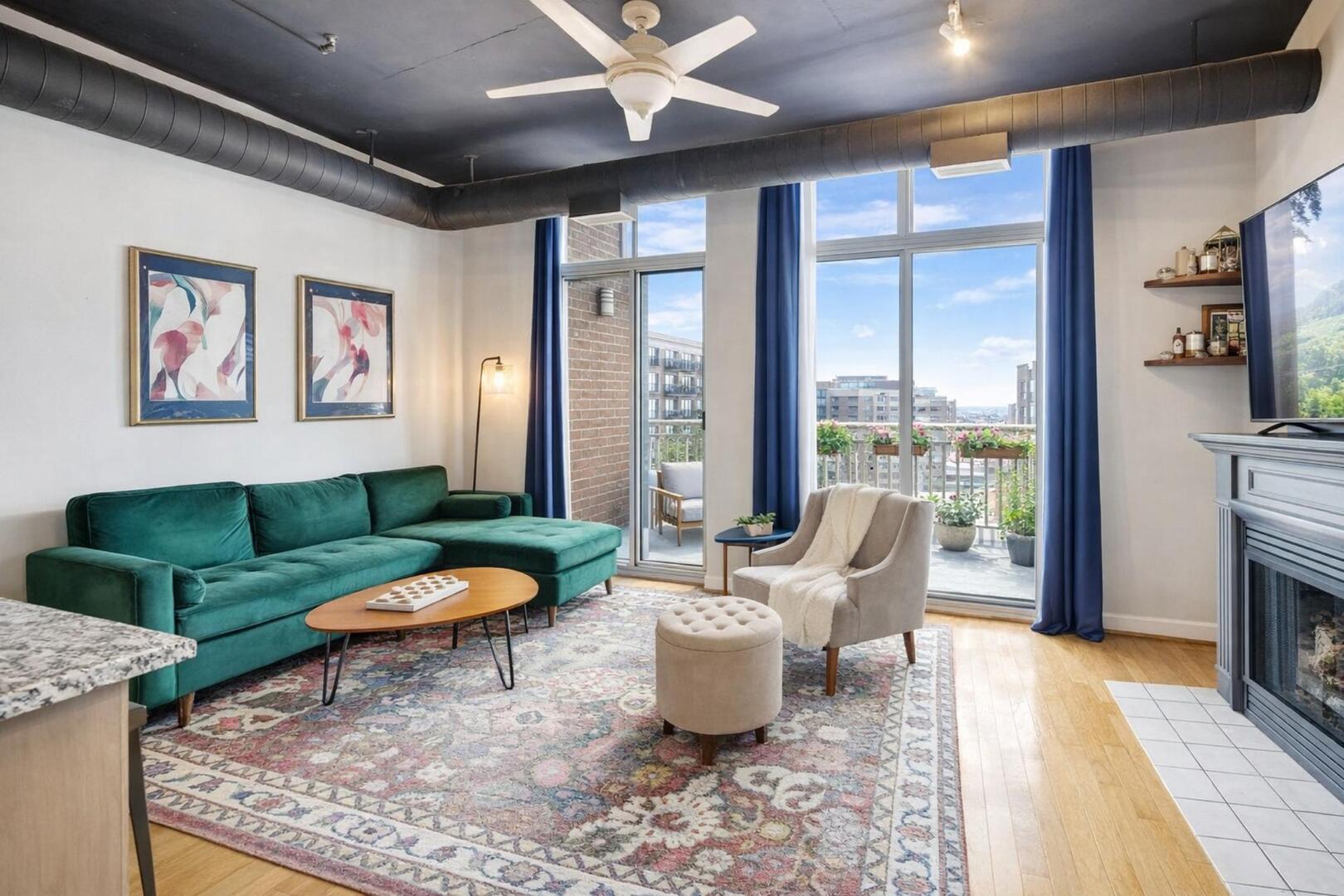 111 South Morgan Street, Unit 703 Chicago, IL 60607 - Photo 9 of 26 a living room with furniture a fireplace and a floor to ceiling window