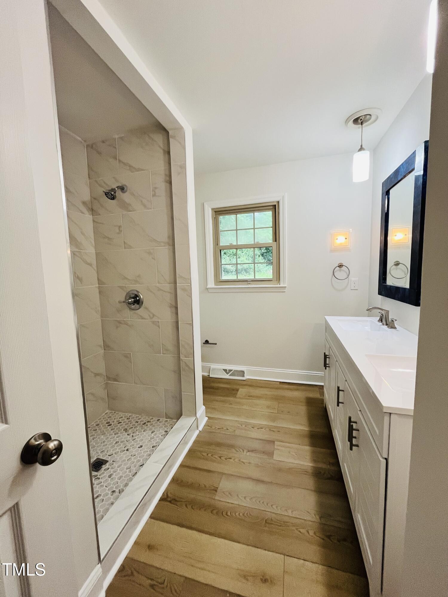 120 Dundee Road Fayetteville, NC 28303 - Photo 12 of 32 a bathroom with a granite countertop sink a mirror a shower and vanity