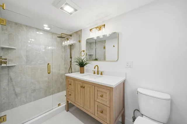 a bathroom with a sink a mirror and a shower