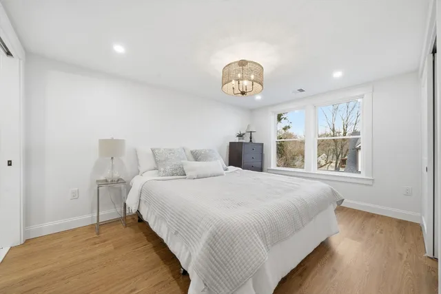 a spacious bedroom with a bed and a window