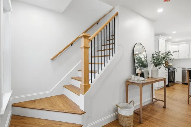 a view of entryway and hall with wooden floor