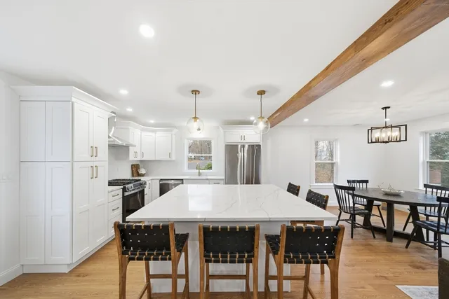 a large kitchen with a table and chairs