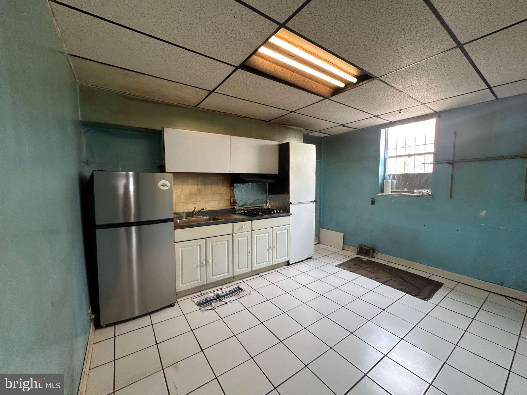 715 West Ritner Street Philadelphia, PA 19148 - Photo 14 of 19 a kitchen with a refrigerator sink and cabinets