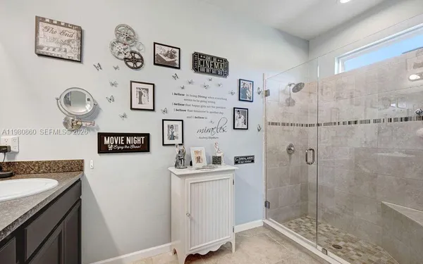a bathroom with a sink a mirror and a shower