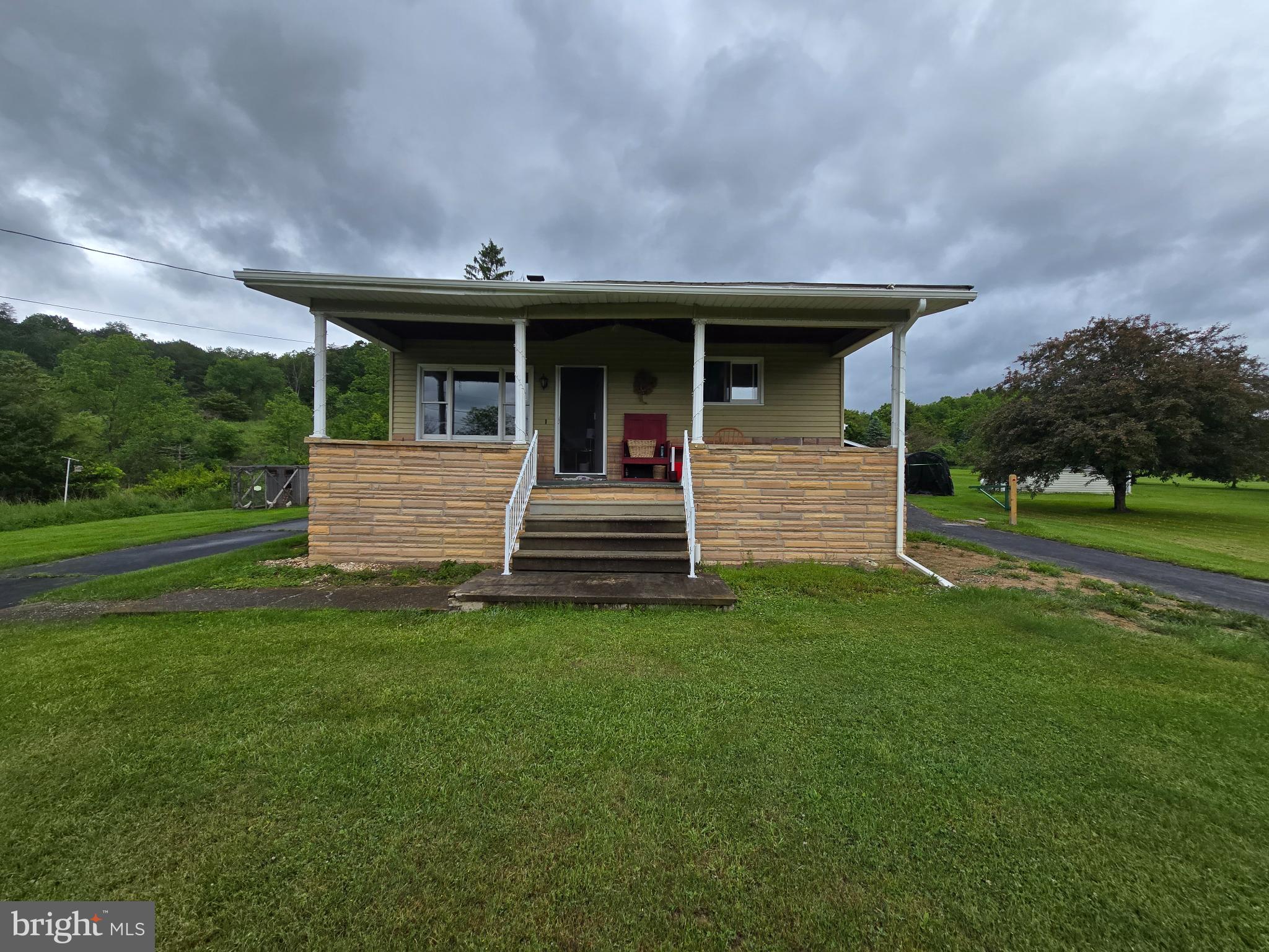11825 Mason Road Northeast Cumberland, MD 21502 - Photo 1 of 26 Charming home with inviting porch and greenery.