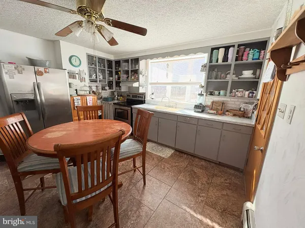 a dining room with furniture and window