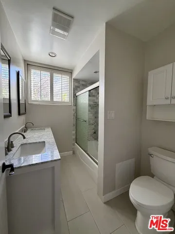a bathroom with a toilet sink and shower