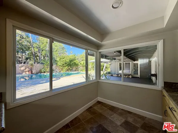 a view of room with window and furniture