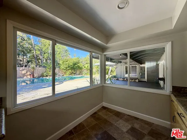 a view of room with window and furniture