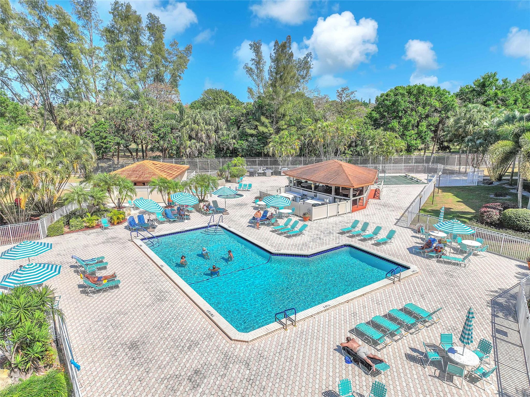 3910 Inverrary Boulevard, Unit 308B Lauderhill, FL 33319 - Photo 1 of 53 a view of a swimming pool with lawn chairs under an umbrella