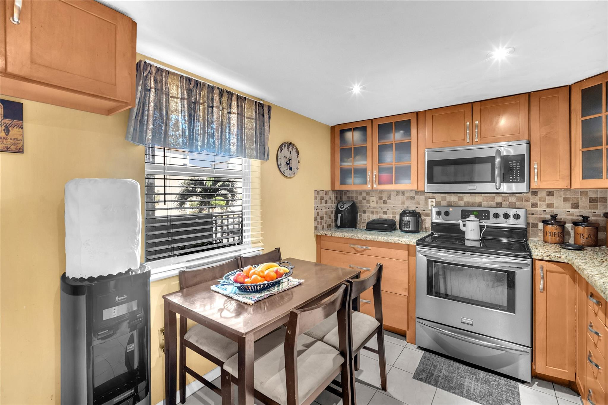 3910 Inverrary Boulevard, Unit 308B Lauderhill, FL 33319 - Photo 11 of 53 a kitchen with a stove a sink and cabinets