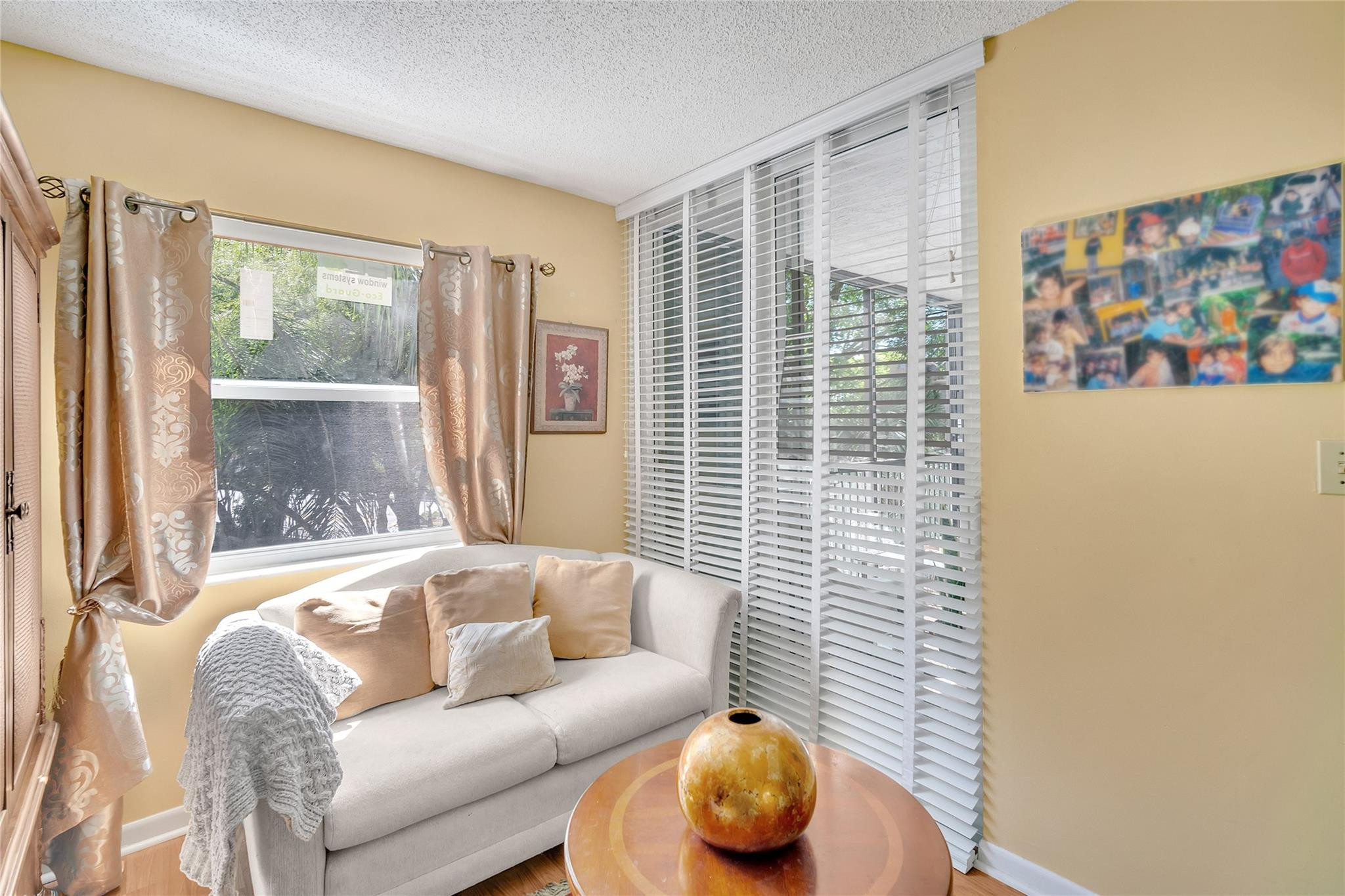 3910 Inverrary Boulevard, Unit 308B Lauderhill, FL 33319 - Photo 17 of 53 a living room with furniture and a window
