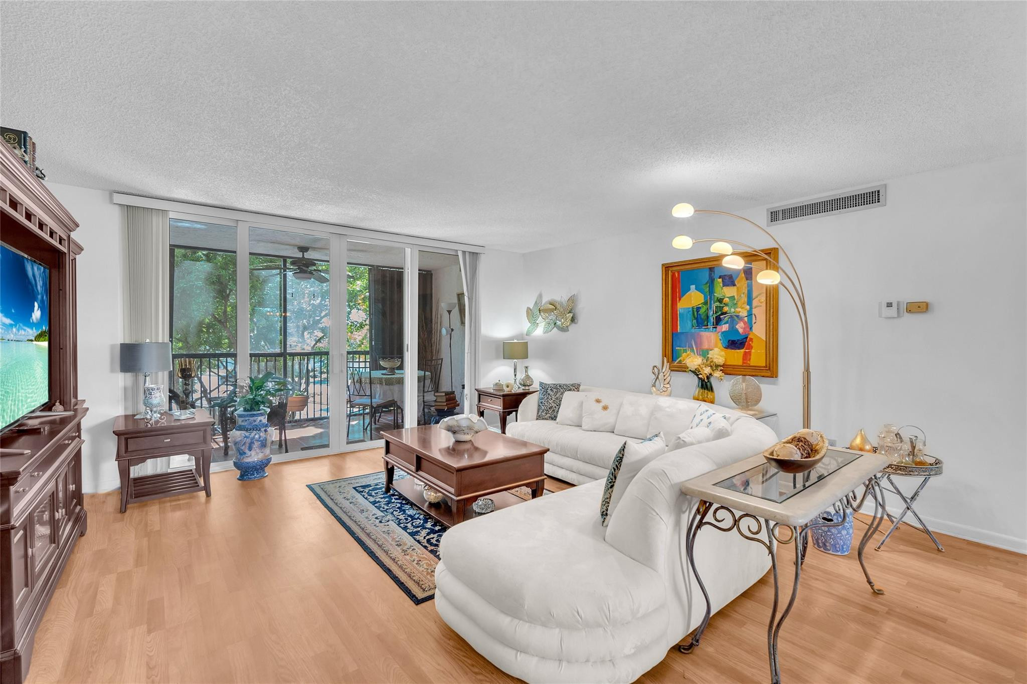 3910 Inverrary Boulevard, Unit 308B Lauderhill, FL 33319 - Photo 25 of 53 a living room with furniture and a large window