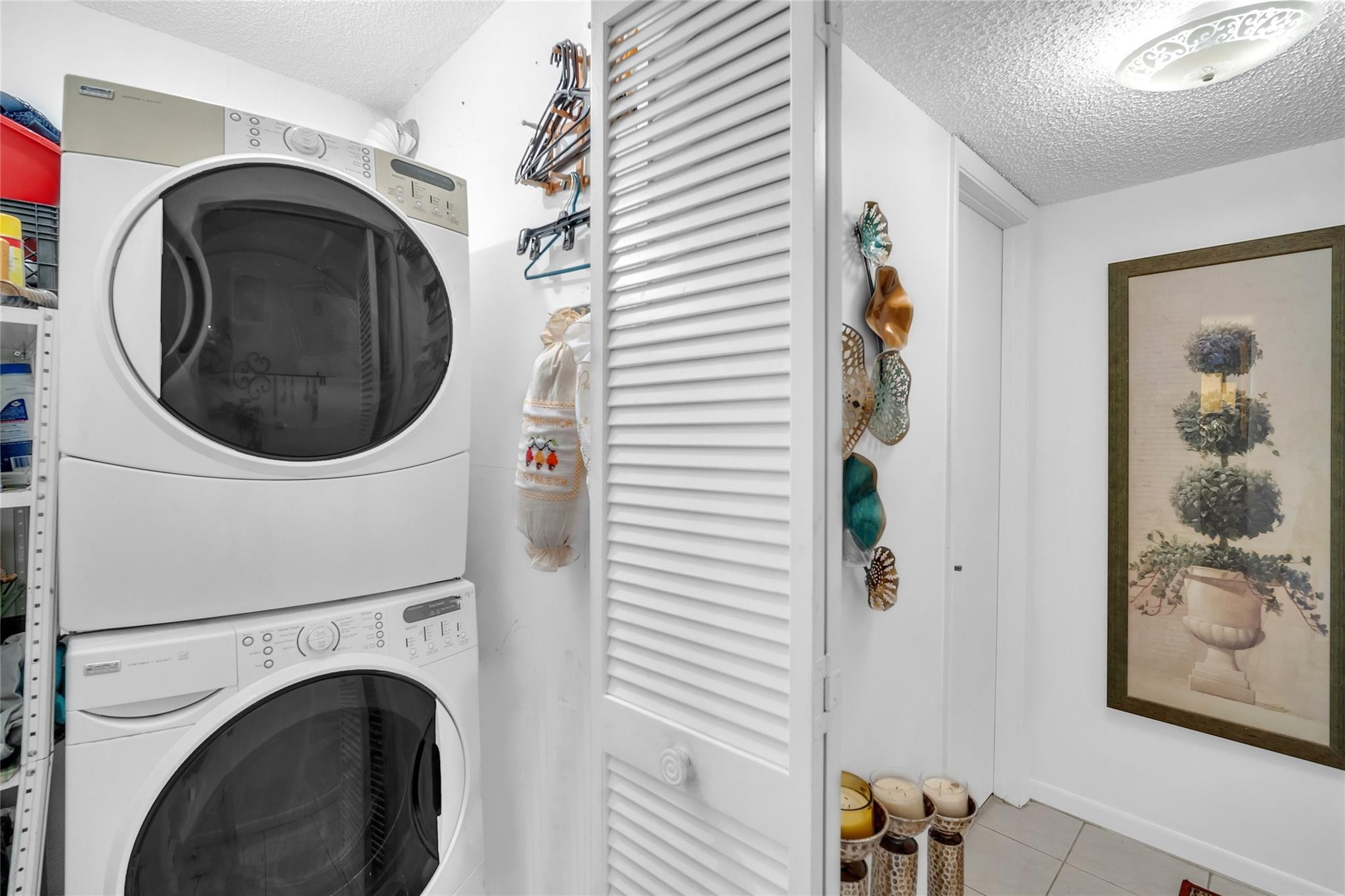 3910 Inverrary Boulevard, Unit 308B Lauderhill, FL 33319 - Photo 29 of 53 a view of a hallway with washer and dryer