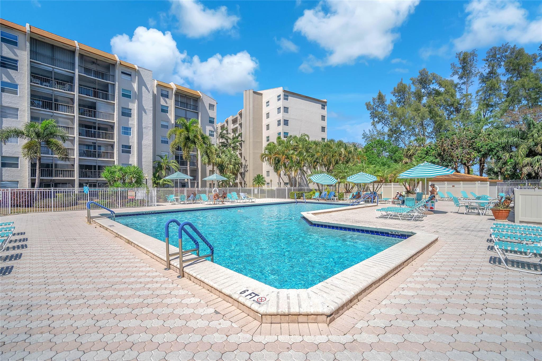3910 Inverrary Boulevard, Unit 308B Lauderhill, FL 33319 - Photo 40 of 53 a view of a swimming pool with a lounge chairs
