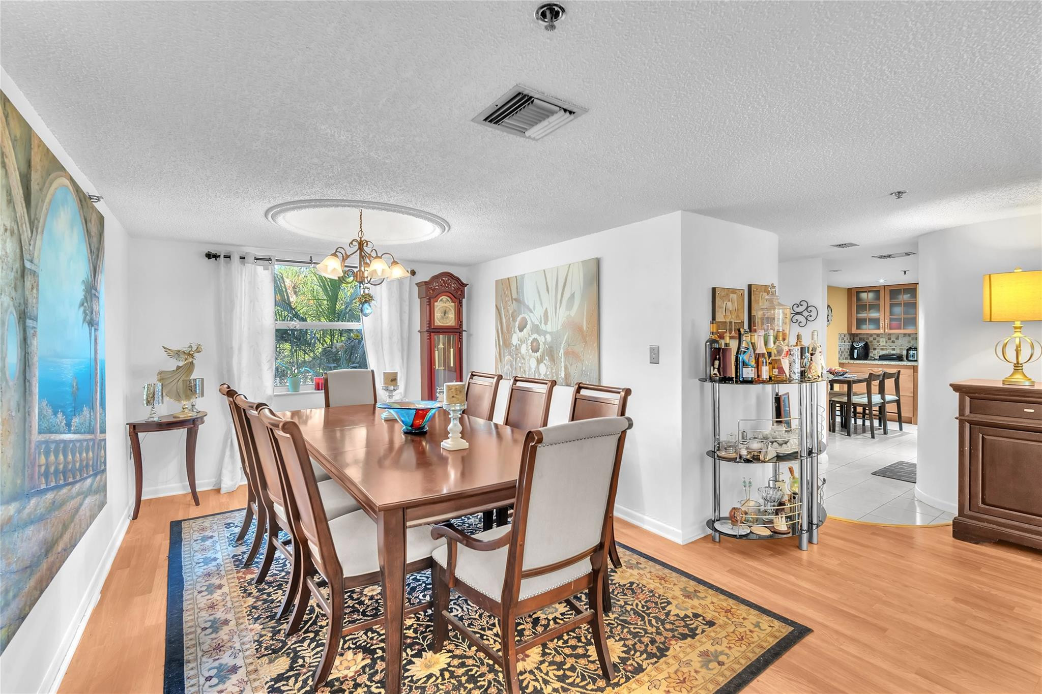 3910 Inverrary Boulevard, Unit 308B Lauderhill, FL 33319 - Photo 5 of 53 a dining room with furniture a rug and wooden floor
