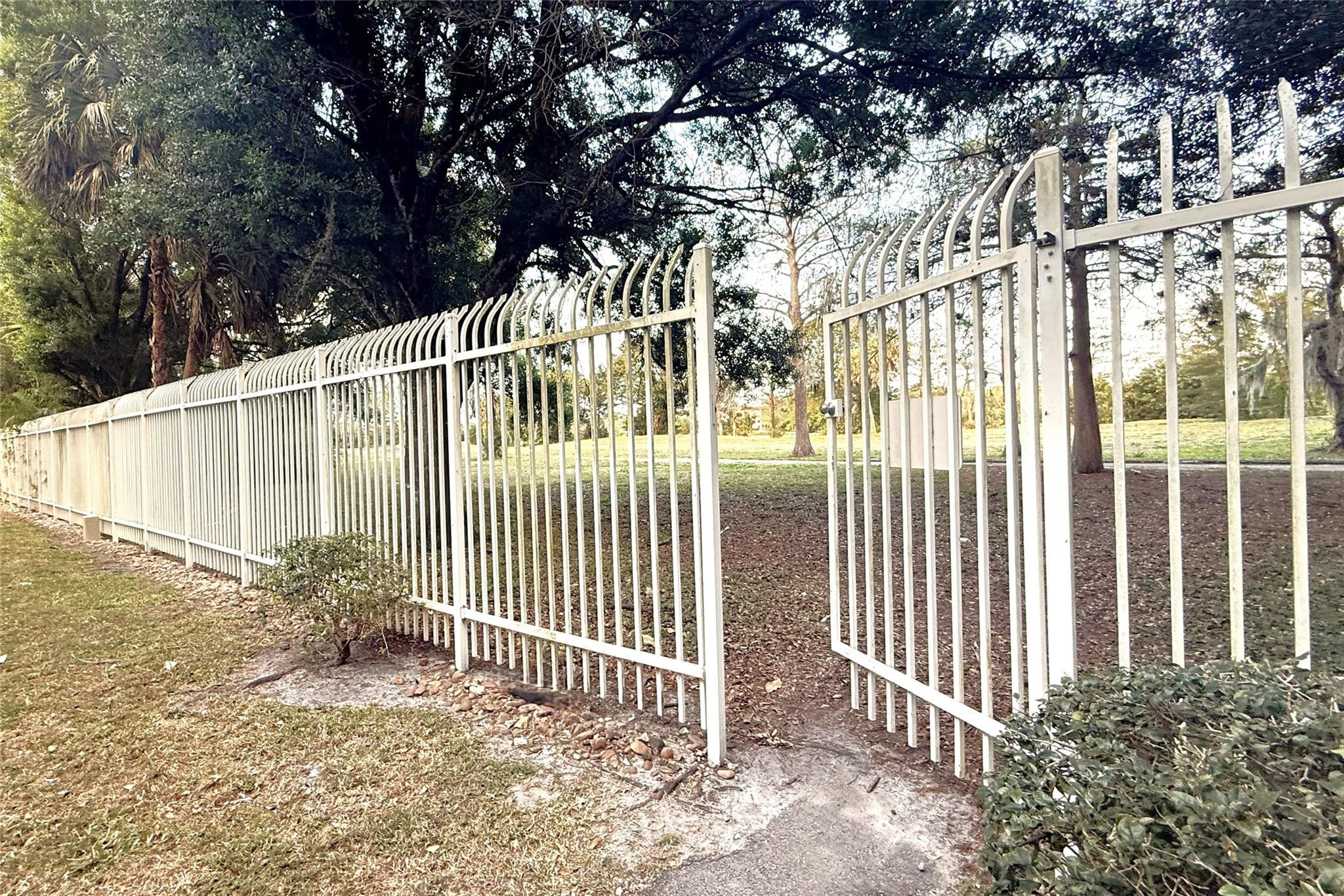3910 Inverrary Boulevard, Unit 308B Lauderhill, FL 33319 - Photo 53 of 53 a view of a house with a small yard and wooden fence