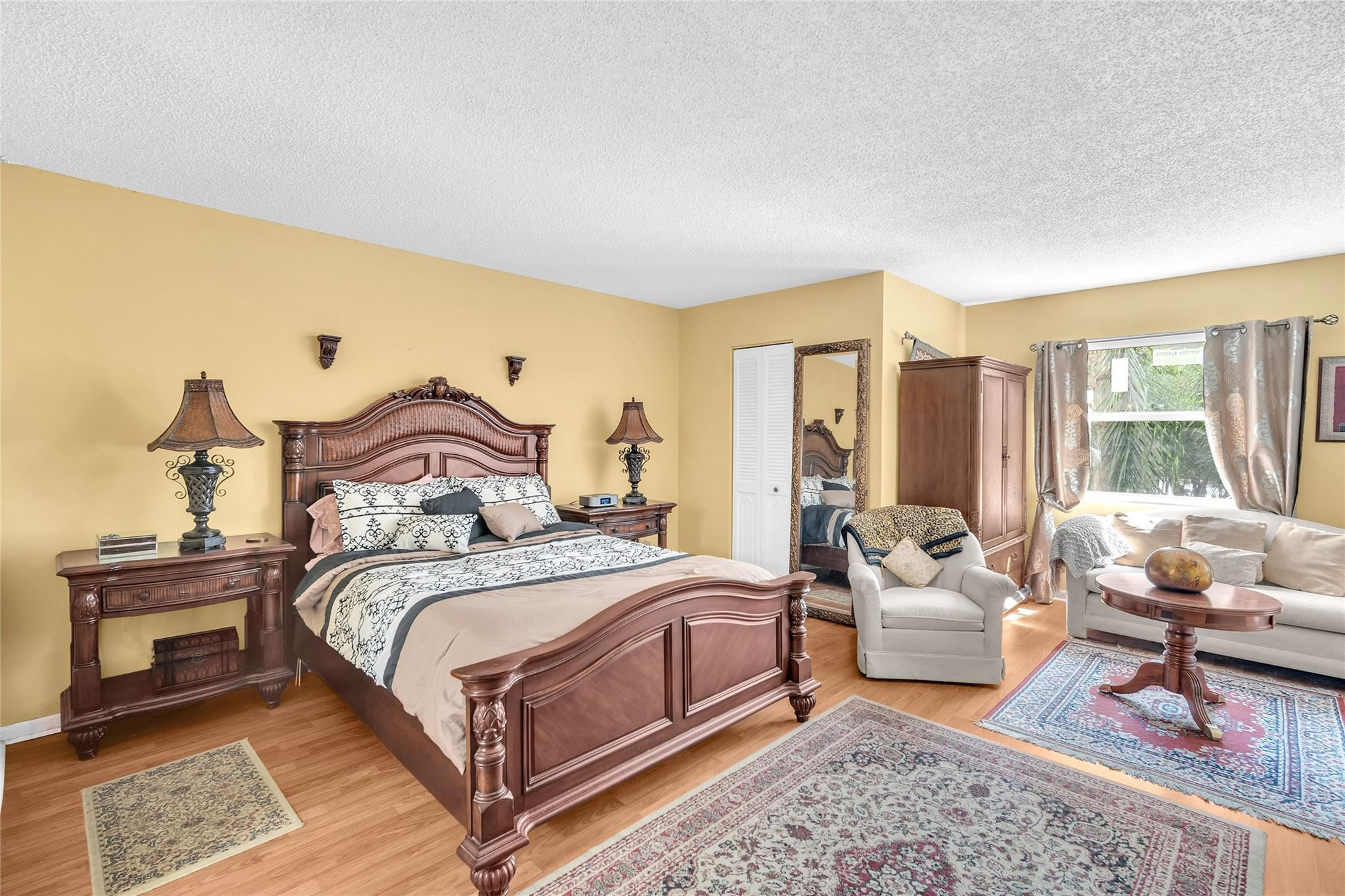 3910 Inverrary Boulevard, Unit 308B Lauderhill, FL 33319 - Photo 7 of 53 a bedroom with a bed and large windows