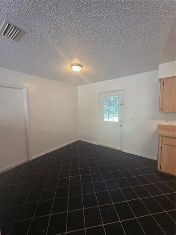 a view of an empty room and a window