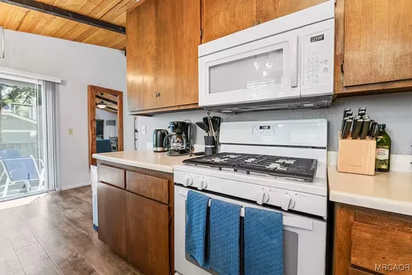 a kitchen with stainless steel appliances granite countertop a stove and a microwave