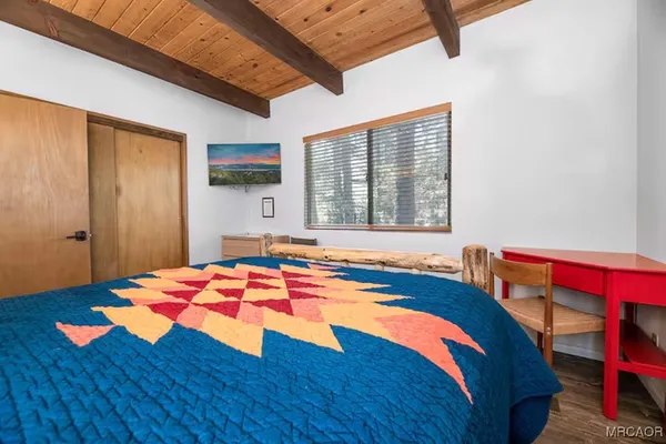 a bedroom with a bed and a small yard