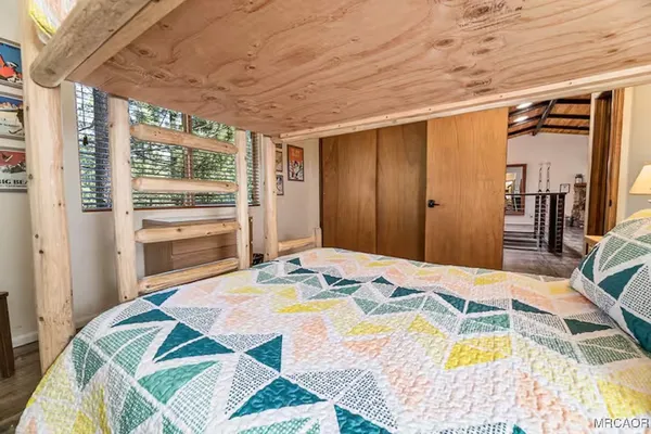a bed sitting in a bedroom next to a window