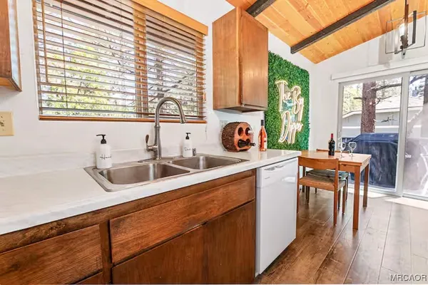 a kitchen with a sink a counter top space and cabinets