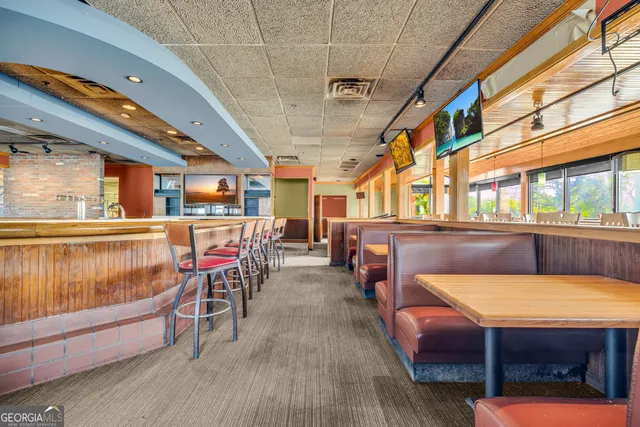 a dinning area with pool table and chairs