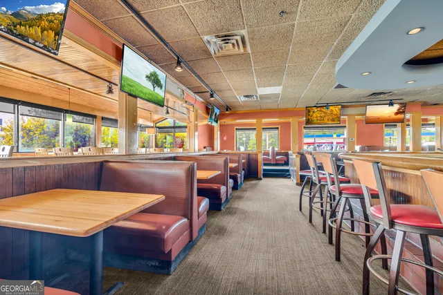a room with a table chairs and a chandelier