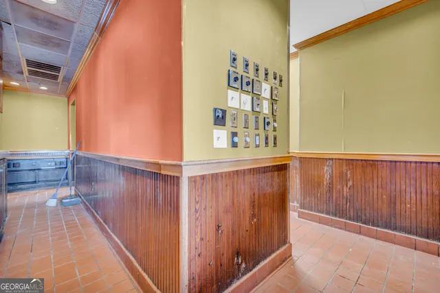 a kitchen with stainless steel appliances kitchen island granite countertop a refrigerator and a sink