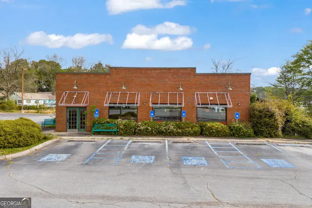 a view of a white house with a yard