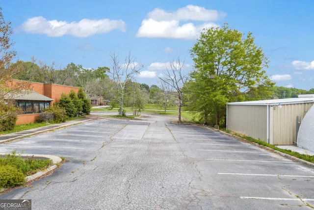 a living room with patio furniture and a large window