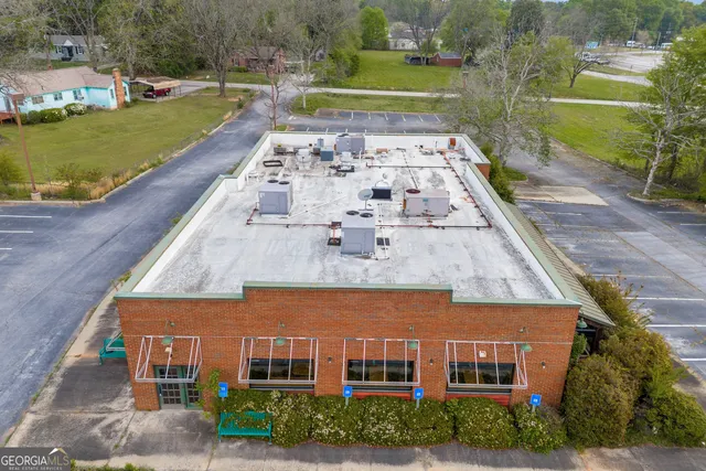 a living room with furniture a large window and wooden floor