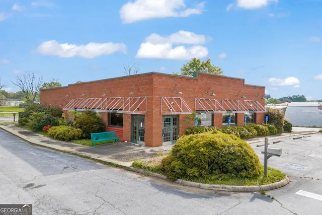 a view of a garden with a building in the background