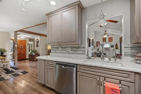 a kitchen with stainless steel appliances granite countertop a stove a sink and a microwave